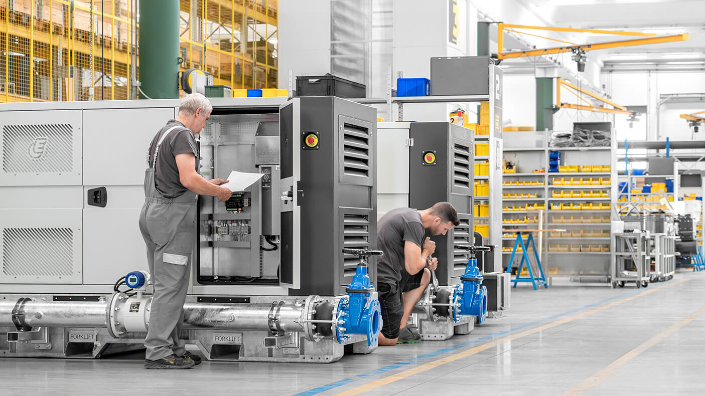 Euromacchine production. Workers assembling industrial pump units inside Euromacchine factory.