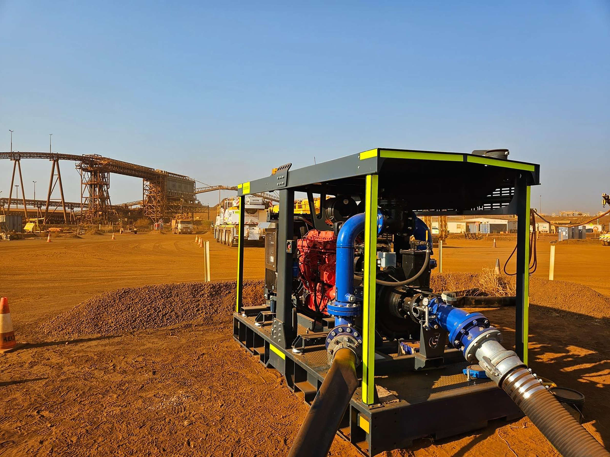 Euromacchine water transfer. Industrial pump operating in a mining site with pipelines connected.